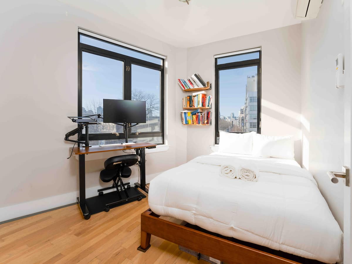 Bedroom with standing desk and monitor